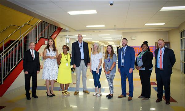 Administrators and State officials pose for a photo